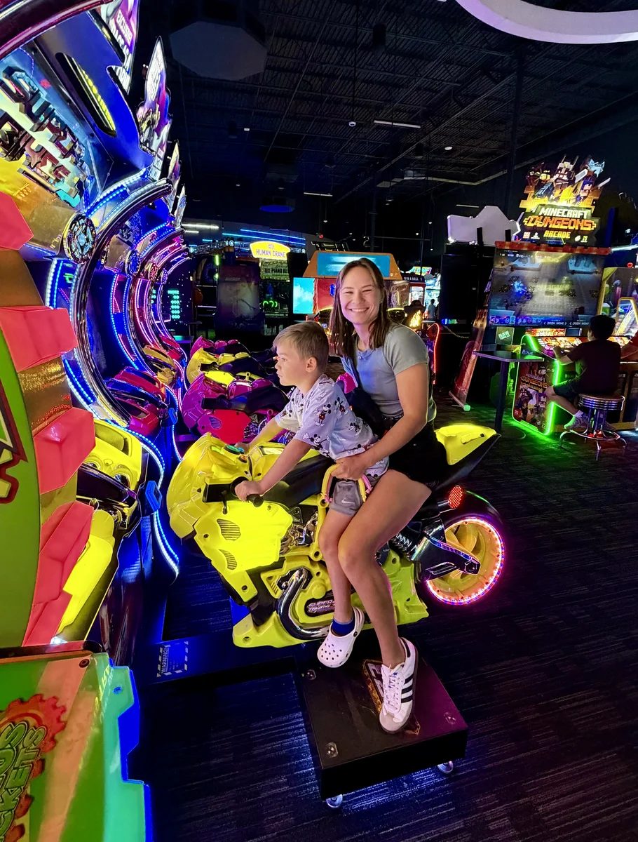 A parent and child sharing a joyful moment at a Fundamentally Awesome sensory-friendly event